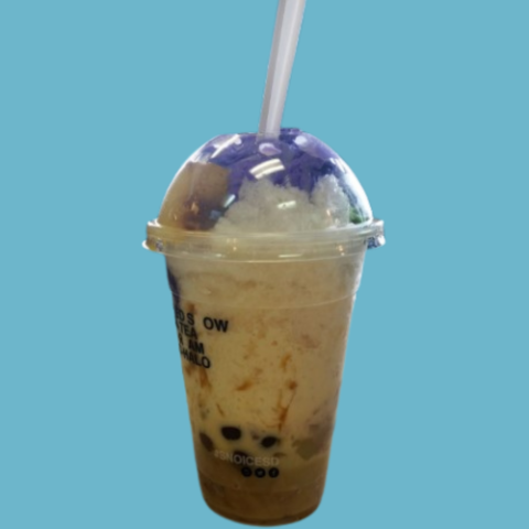 A clear lidded cup containing a creamy frothed specialty beverage